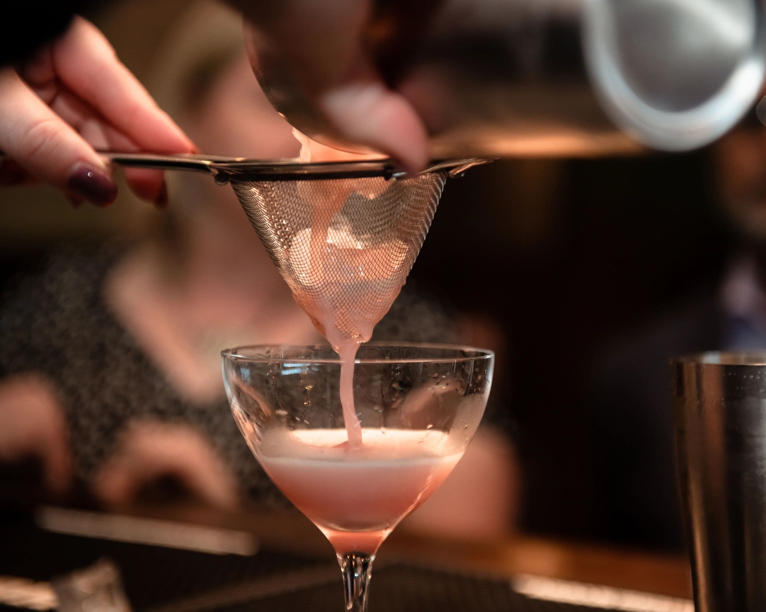 Handcrafted cocktail being poured at Palace Rooms